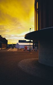 Preview wallpaper sunset, city, architecture, evening, shadows, yellow