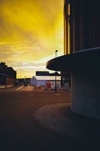 Preview wallpaper sunset, city, architecture, evening, shadows, yellow