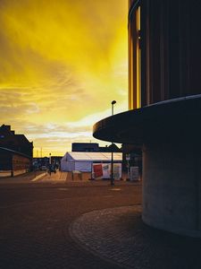 Preview wallpaper sunset, city, architecture, evening, shadows, yellow