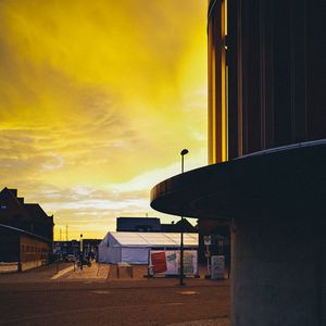 Preview wallpaper sunset, city, architecture, evening, shadows, yellow