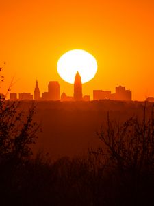 Preview wallpaper sunset, city, buildings, silhouette, sun, dusk