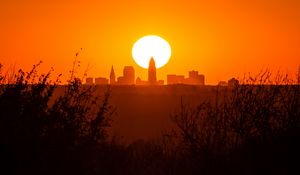 Preview wallpaper sunset, city, buildings, silhouette, sun, dusk