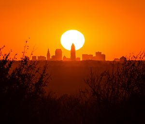 Preview wallpaper sunset, city, buildings, silhouette, sun, dusk