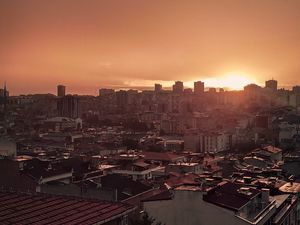 Preview wallpaper sunset, city, buildings, aerial view, dusk