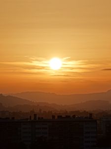 Preview wallpaper sunset, city, buildings, mountains, dusk
