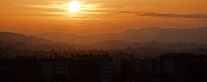 Preview wallpaper sunset, city, buildings, mountains, dusk