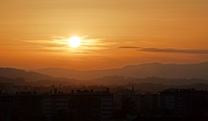 Preview wallpaper sunset, city, buildings, mountains, dusk