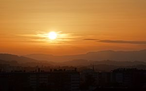 Preview wallpaper sunset, city, buildings, mountains, dusk