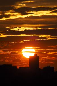 Preview wallpaper sunset, city, dark, buildings, silhouettes