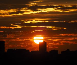 Preview wallpaper sunset, city, dark, buildings, silhouettes