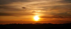 Preview wallpaper sunset, clouds, hills, sun, sky