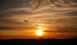 Preview wallpaper sunset, clouds, hills, sun, sky