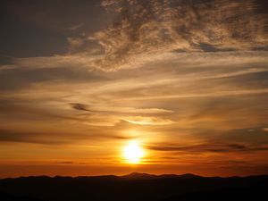 Preview wallpaper sunset, clouds, hills, sun, sky
