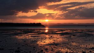 Preview wallpaper sunset, coast, dusk, sun, clouds