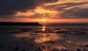 Preview wallpaper sunset, coast, dusk, sun, clouds
