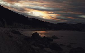 Preview wallpaper sunset, coast, stones, dark