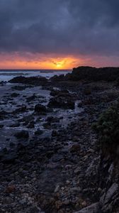 Preview wallpaper sunset, coast, stones, sea, horizon