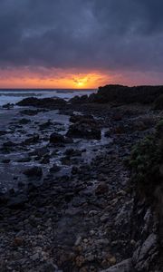 Preview wallpaper sunset, coast, stones, sea, horizon