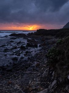 Preview wallpaper sunset, coast, stones, sea, horizon