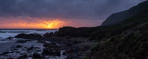 Preview wallpaper sunset, coast, stones, sea, horizon