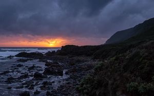 Preview wallpaper sunset, coast, stones, sea, horizon