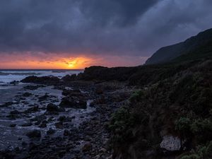 Preview wallpaper sunset, coast, stones, sea, horizon