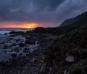 Preview wallpaper sunset, coast, stones, sea, horizon