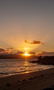 Preview wallpaper sunset, coast, sun, sea, clouds