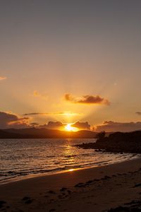 Preview wallpaper sunset, coast, sun, sea, clouds
