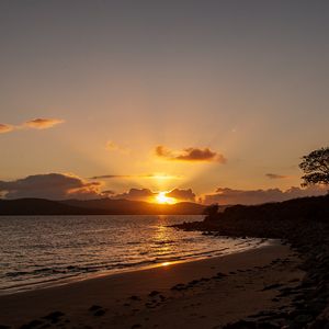 Preview wallpaper sunset, coast, sun, sea, clouds