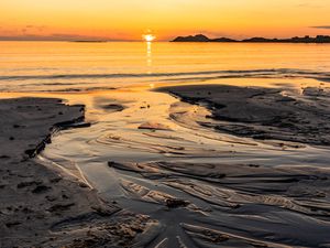 Preview wallpaper sunset, glare, sea, coast, sand