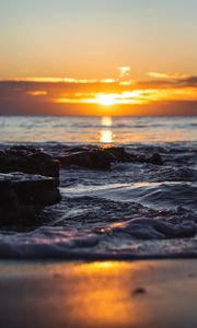 Preview wallpaper sunset, glare, sea, stones, rocks