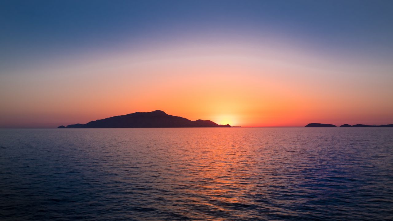 Wallpaper sunset, hills, sea, glare, sky