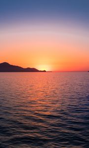 Preview wallpaper sunset, hills, sea, glare, sky