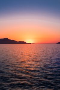 Preview wallpaper sunset, hills, sea, glare, sky
