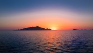 Preview wallpaper sunset, hills, sea, glare, sky