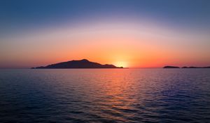 Preview wallpaper sunset, hills, sea, glare, sky
