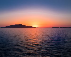 Preview wallpaper sunset, hills, sea, glare, sky