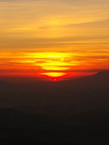 Preview wallpaper sunset, horizon, glow, mountains, clouds, red