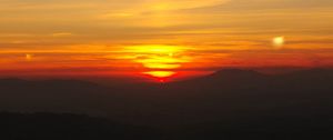 Preview wallpaper sunset, horizon, glow, mountains, clouds, red