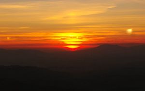Preview wallpaper sunset, horizon, glow, mountains, clouds, red