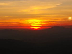 Preview wallpaper sunset, horizon, glow, mountains, clouds, red