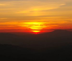 Preview wallpaper sunset, horizon, glow, mountains, clouds, red