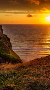 Preview wallpaper sunset, horizon, rock, water surface, grass