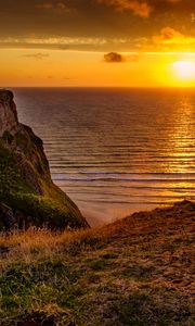 Preview wallpaper sunset, horizon, rock, water surface, grass