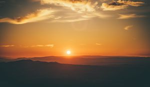 Preview wallpaper sunset, horizon, sun, hills, orange