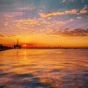 Preview wallpaper sunset, horizon, water surface, pier