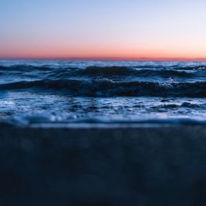 Preview wallpaper sunset, horizon, water surface, waves