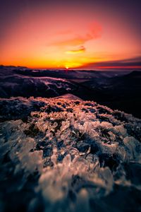 Preview wallpaper sunset, ice, grass, horizon, rocks