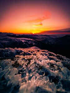 Preview wallpaper sunset, ice, grass, horizon, rocks